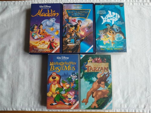 5 VHS-filmer: Aladdin, Skattkammarplaneten, Mästerdetektiven Basil Mus, Tarzan