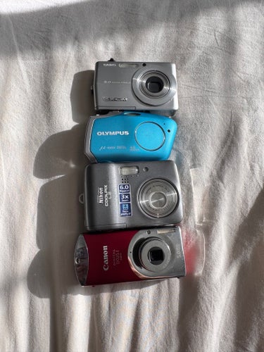 1x Casio 1x Olympus 1x Nikon 1x Canon Ixus Digital Cameras Bundle – Untested