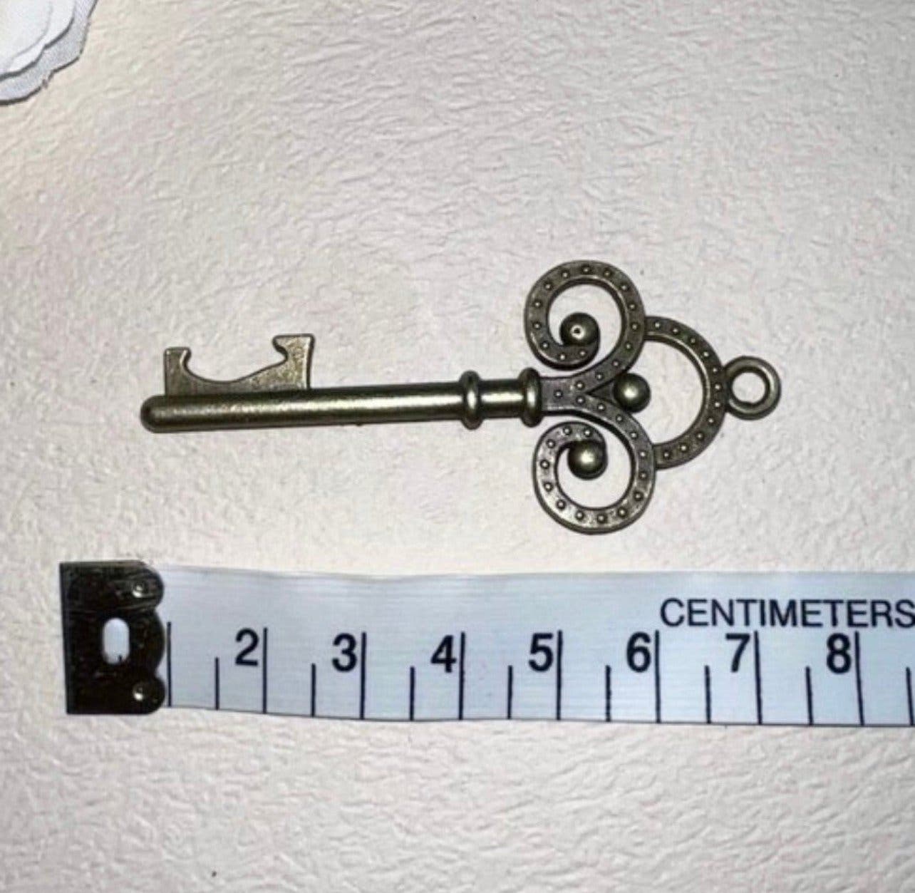 Keyring and bottle opener combined with authentic key weight and shape