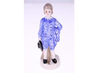Vintage porcelain figurine of a sad boy