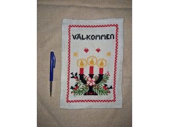Broderad välkomstskylt