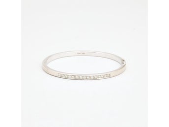 Klassisk armring med lås med diamant (0.39 ct) i 14K guld, 5.9 cm, 9.9 g