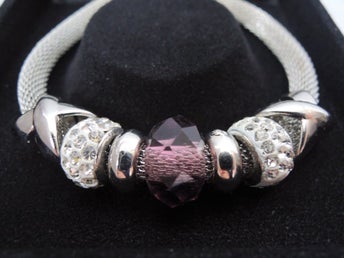 Läckert flätat armband med brunviolett pärla i gåvoask