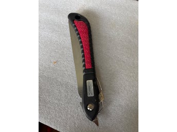 Fällbar såg med rött handtag