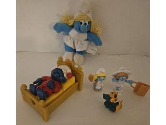 Smurfar samling med figur i säng och mjukisdjur