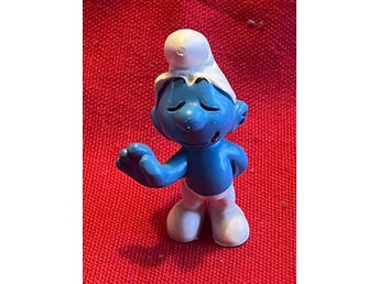 Schleich Smurf Figur blundar och har 1 hand bakom ryggen