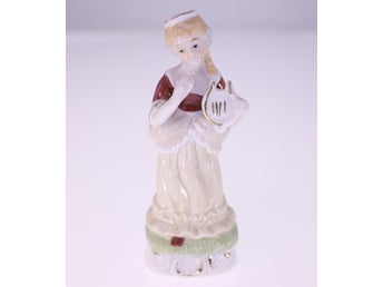 Vintage porcelain lady figurine with harpsichord